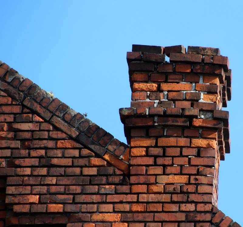 Damaged chimney on an Temple Hills home showing cracks and missing mortar